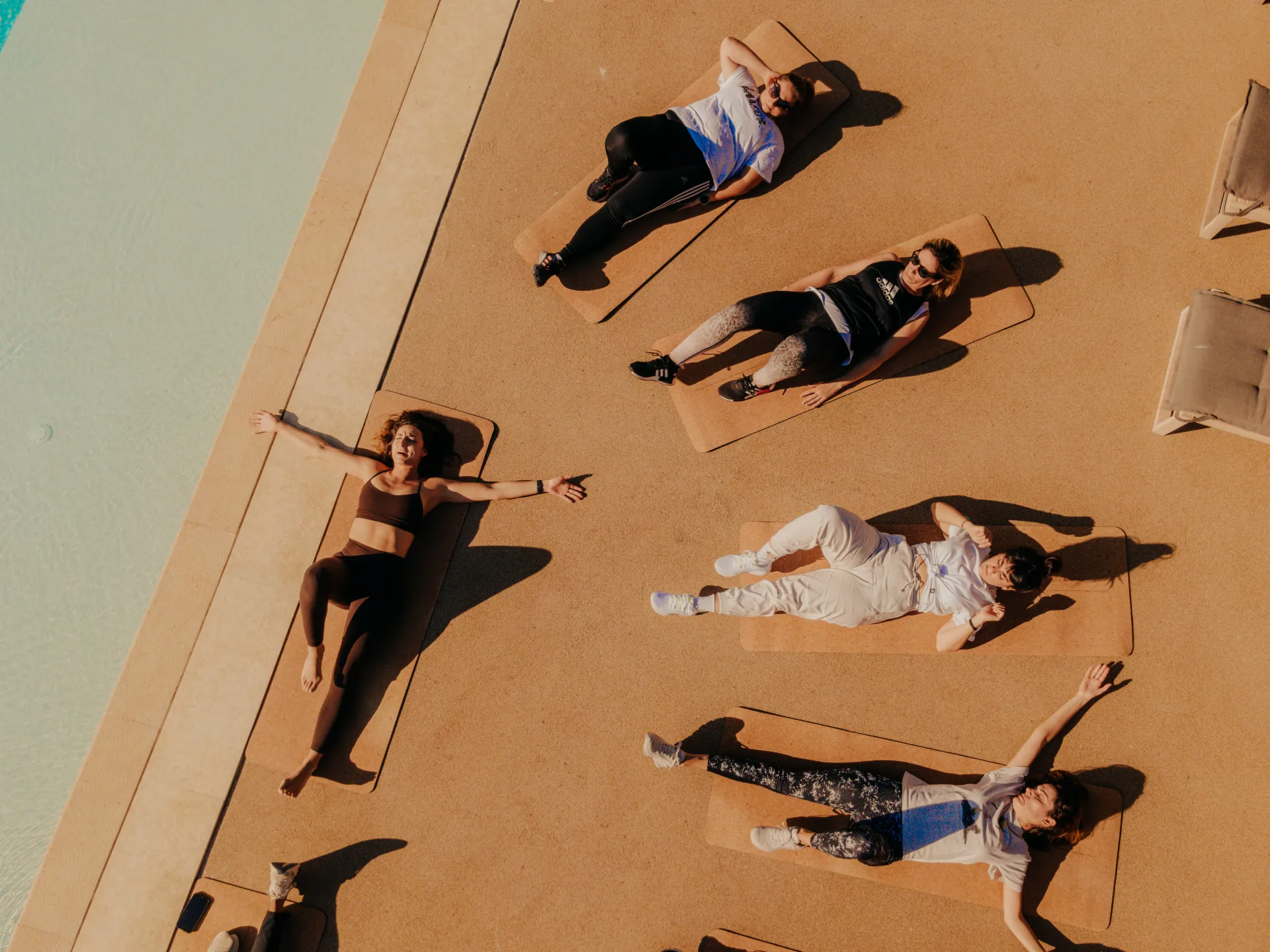 Group in savasana pose during yoga retreat at Villa Naos