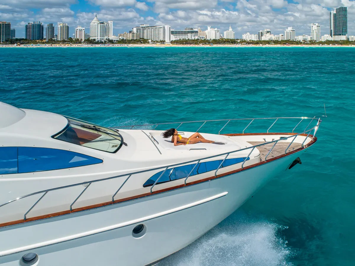 Guest on the bow of the Azimut 84 with the Miami Beach skyline behind, a World Cup off-day charter for match day
