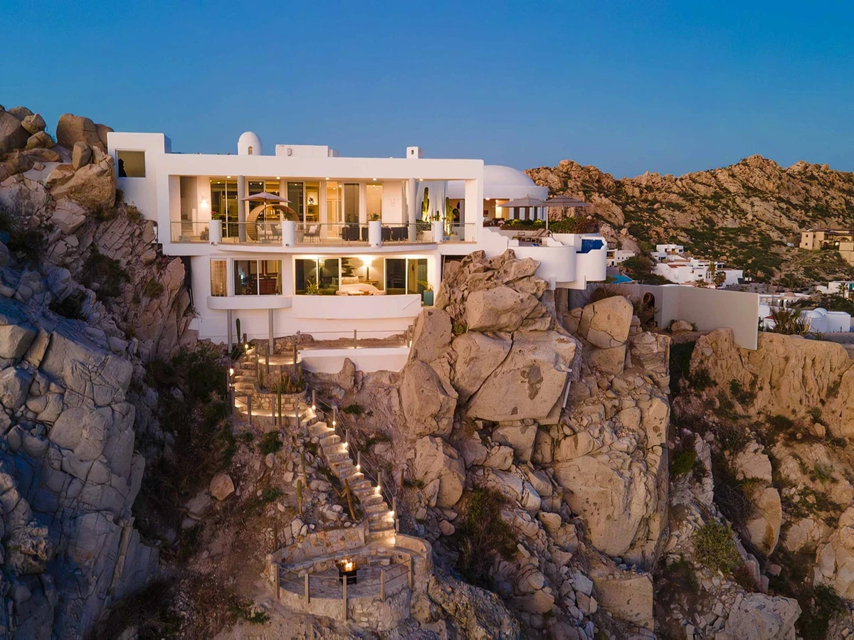 Clifftop private villa on the Pacific side of Pedregal, Cabo San Lucas, with infinity pool and ocean view at golden hour