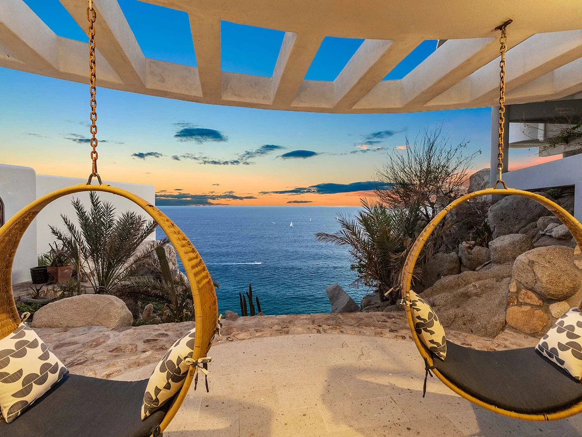 Infinity pool and terrace above the ocean at a Cabo villa