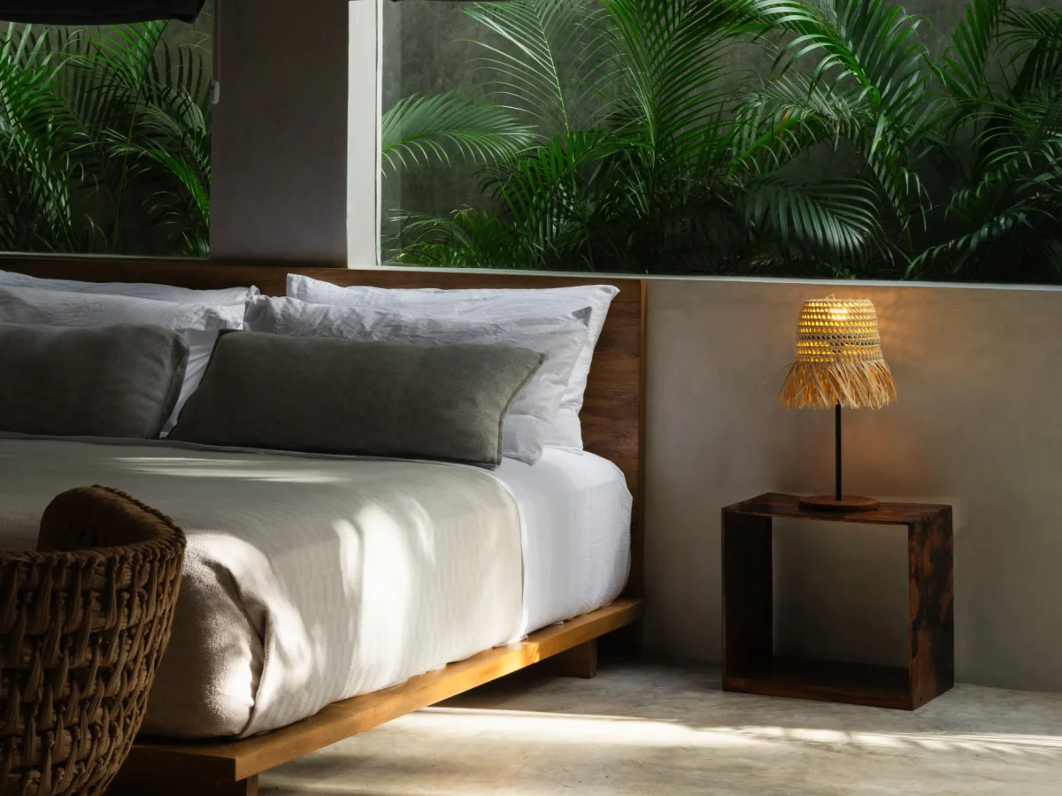 Candlelit terrace seating with low tables in the Tulum jungle
