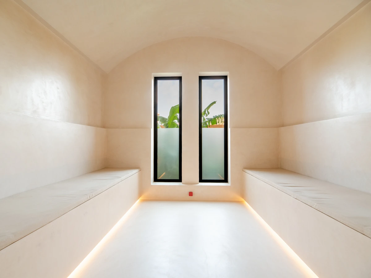 Dar Manou central courtyard set up for an intimate ceremony, Moorish arches and pendant light