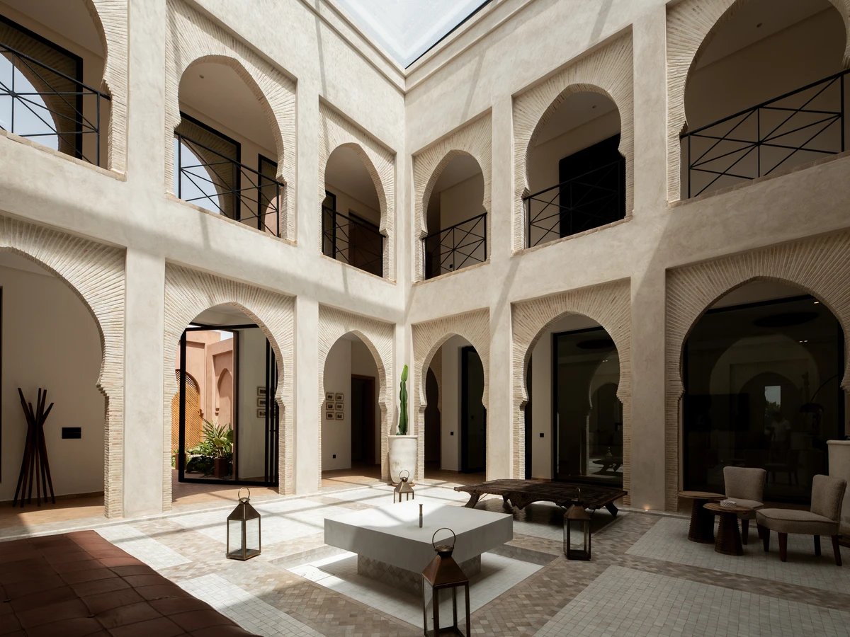 Rooftop terrace with low seating and lanterns in Marrakech
