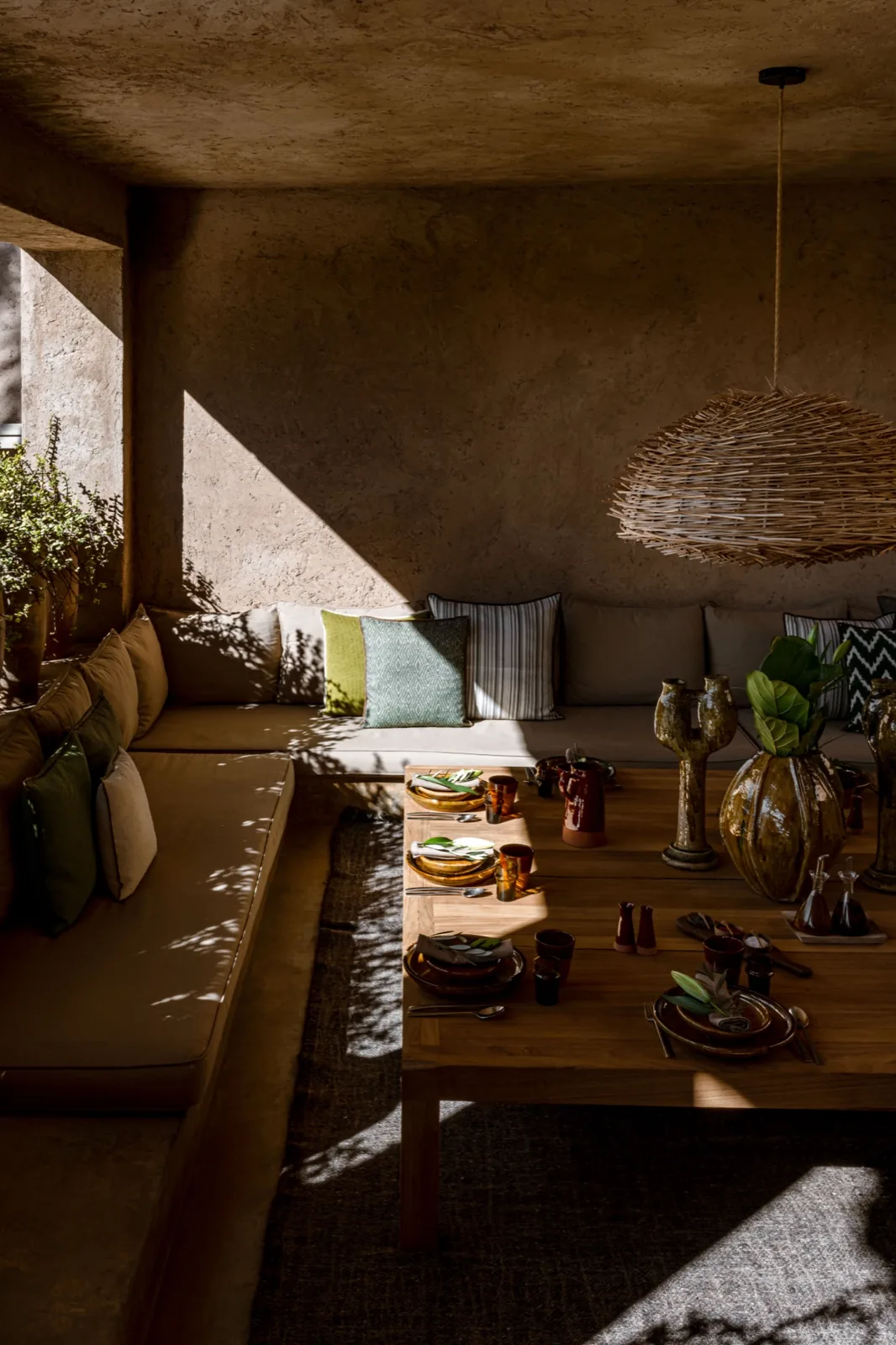 Marrakech Palmeraie villa exterior at dusk with terracotta walls and palm-lined driveway