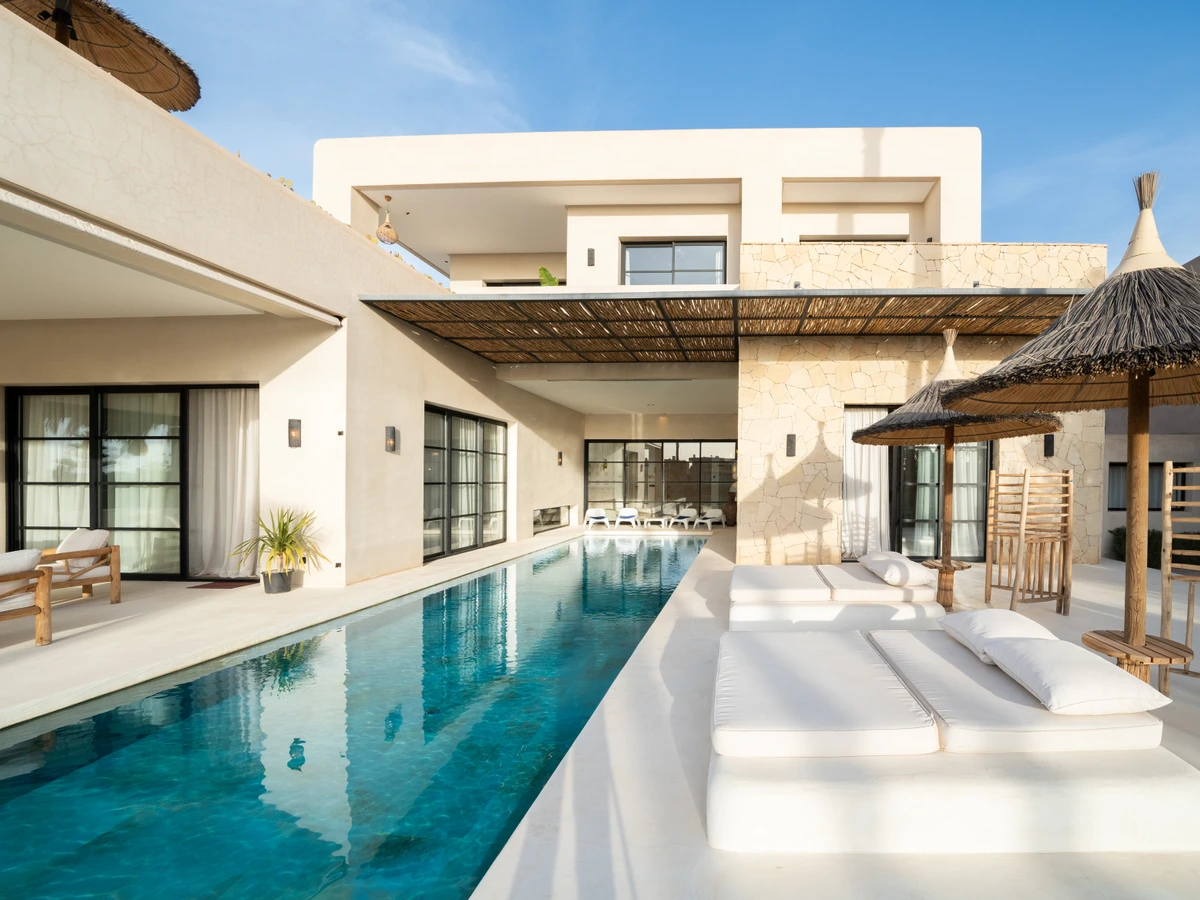 Villa Ibiza wrap-around terrace with Atlas Mountain views, Marrakech, late afternoon light