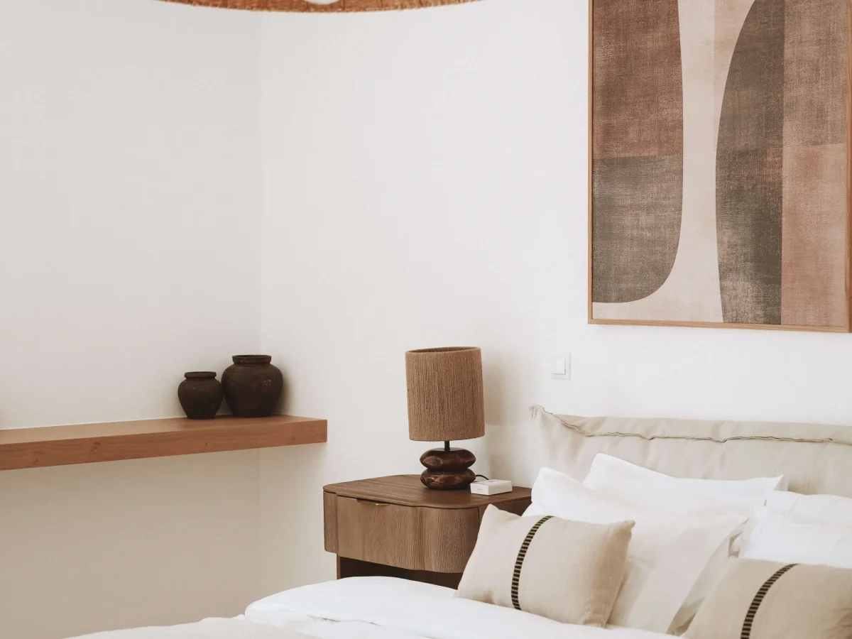 Whitewashed Mykonos villa terrace above the Aegean at golden hour