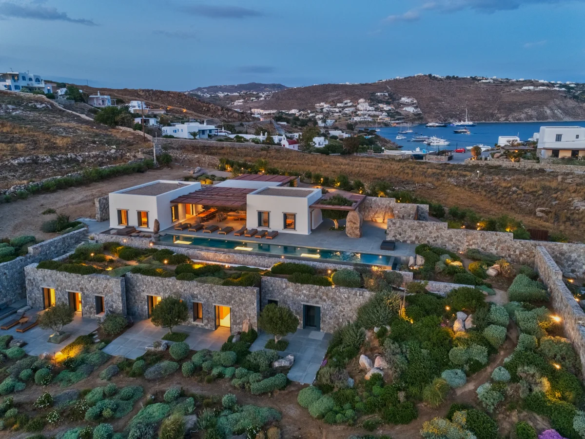 Outdoor dining table shaded by a pergola at a Mykonos villa
