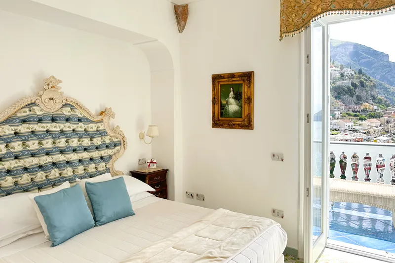 Amalfi Coast clifftop villa terrace with a pool and a wide view of the Tyrrhenian Sea at golden hour