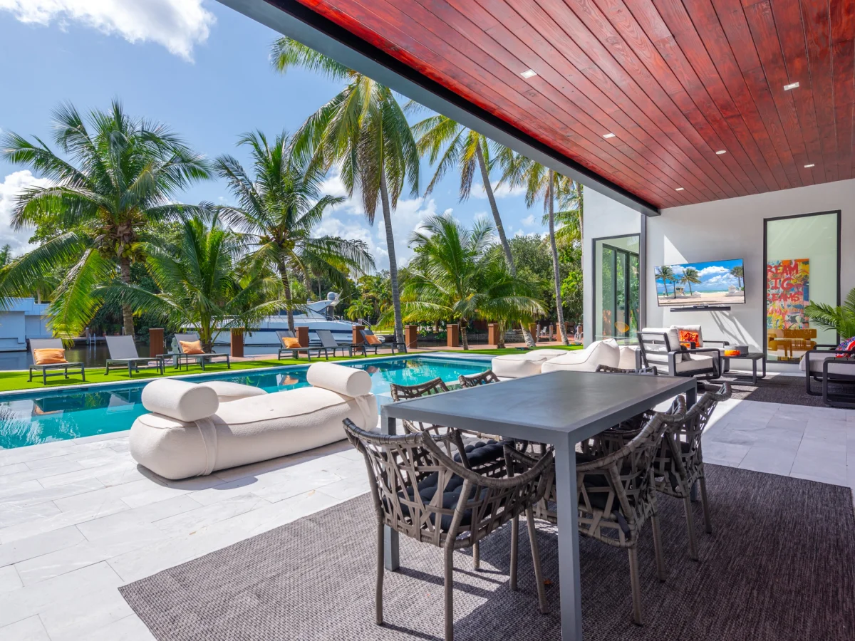 Resort-style pool with sun-shelf loungers and palms at Villa Pesara, a Miami World Cup base for sixteen