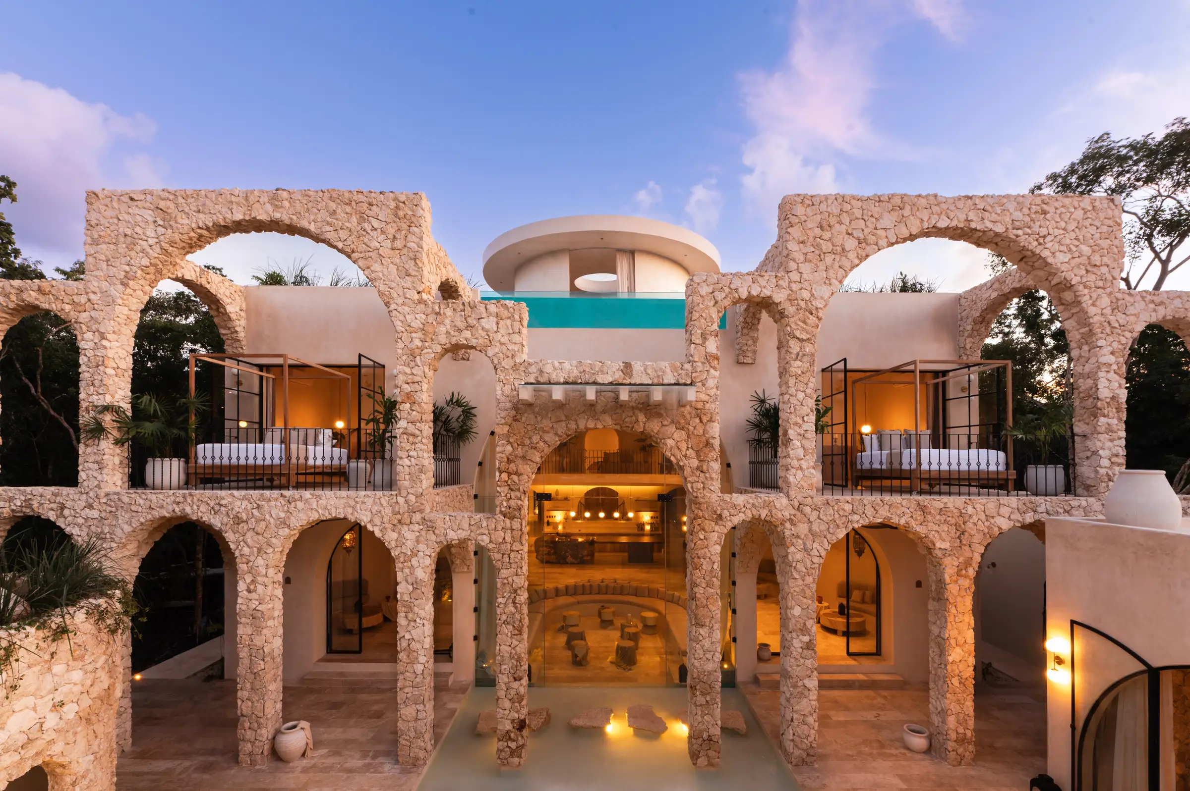 Grand illuminated arches of a luxury villa at twilight