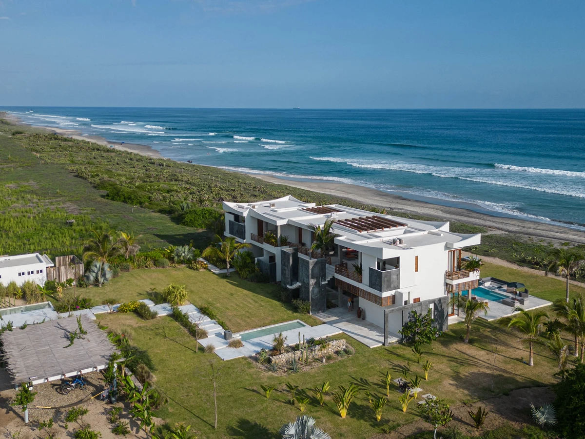 Exclusive beachfront villa with private pool at sunset